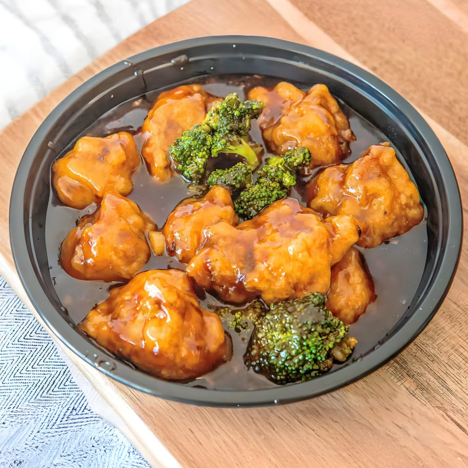 Golden Star's General Tso's chicken with broccoli in a black takeout container.